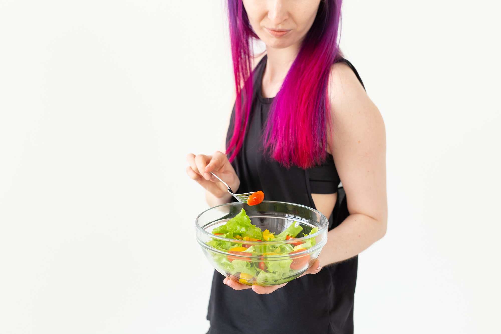 Student plating colorful salad